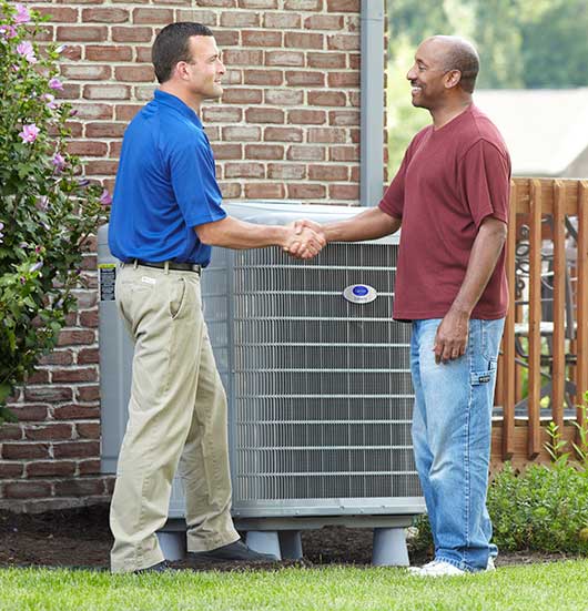 Carrier stock photo with a dealer and home owner